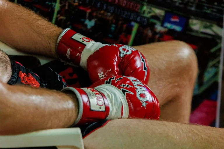 Muay Thai boxer wearing red Muay Thai gloves