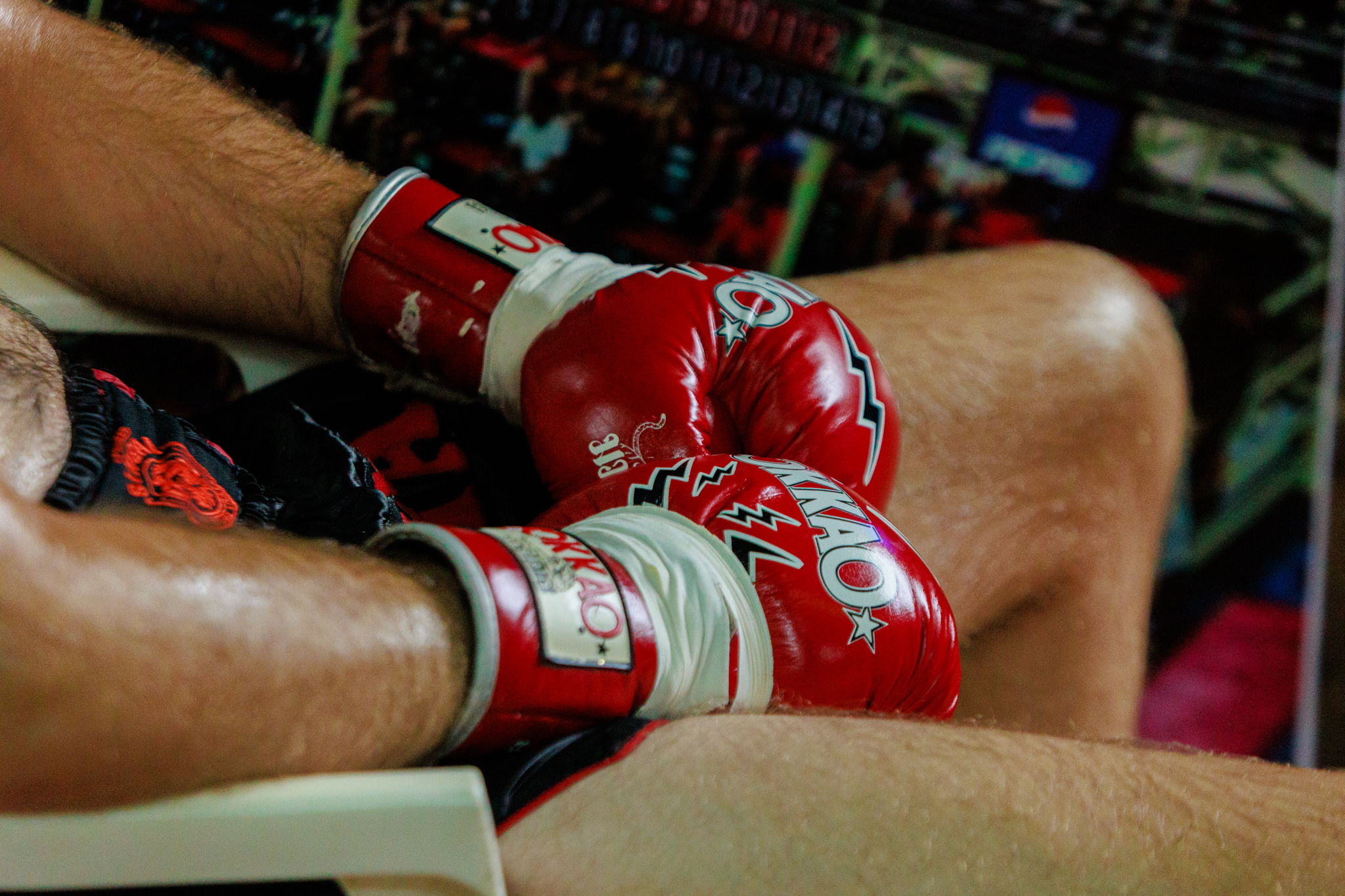 Muay Thai fighter wearing red Muay Thai gloves