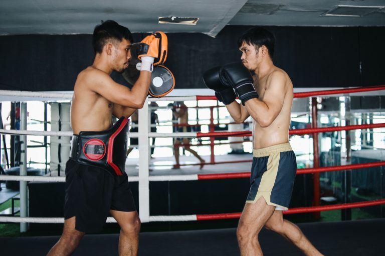 Concentration two Asian fighters men training boxing wear training equipment