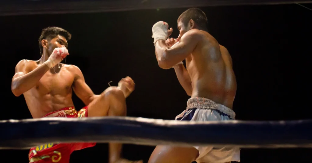 Two Thai boxers Fighting Each Other in the Boxing Ring