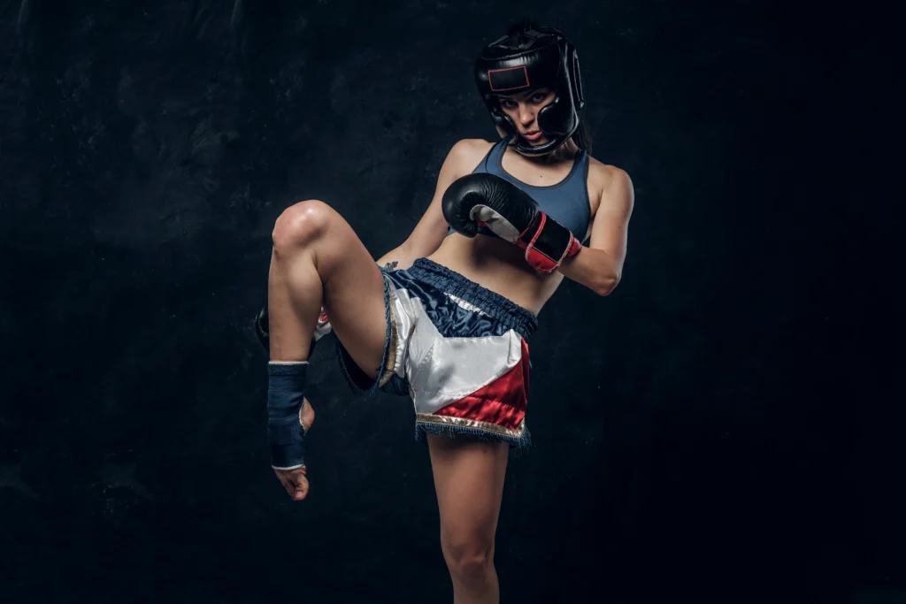 pretty strong woman is demonstrating her kick boxer pose while posing photographer
