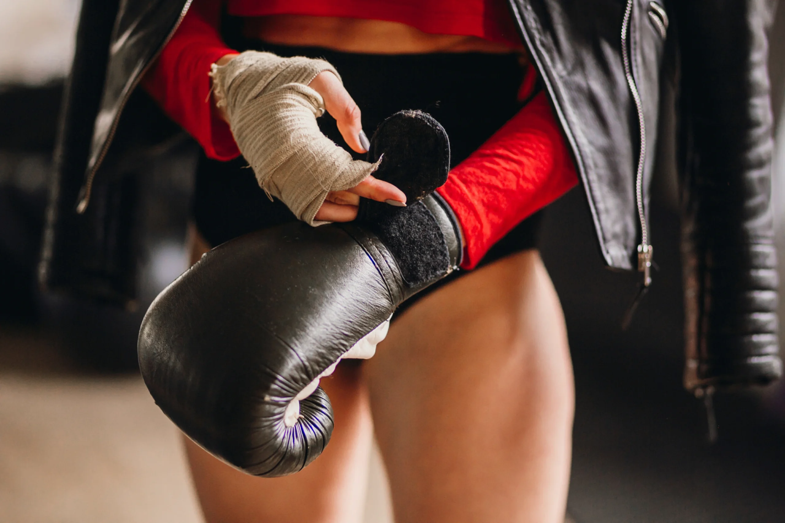 woman leather jacket puts boxing gloves